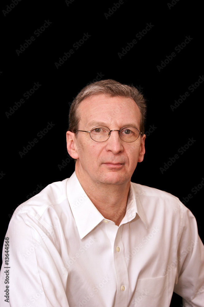 portrait of older serious man in white shirt on black portrait of older serious man in white shirt on black