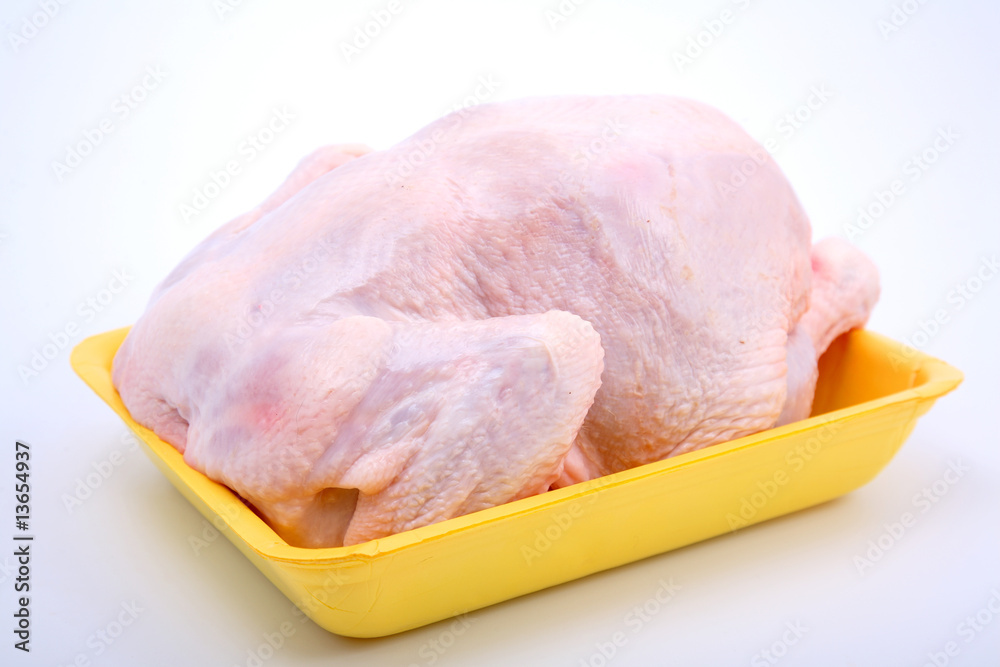 Fresh chicken-broiler (hen) on a yellow substrate Fresh chicken-broiler (hen) on a yellow substrate