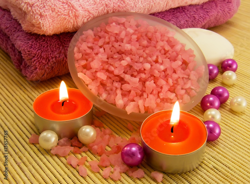 Salt with rose oil, candle and bamboo towels for relaxation