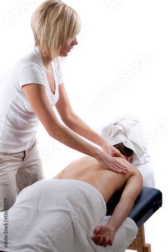 Massage therapist giving back massage