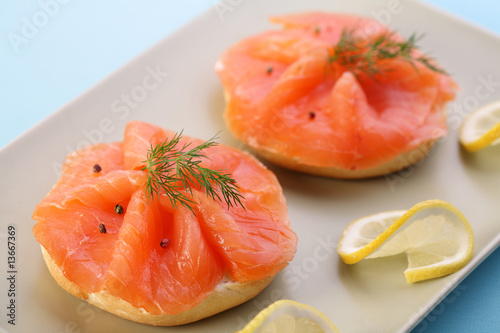 Smoked salmon on bagel with fresh black pepper.