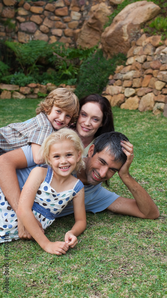 Fototapeta premium Potrait of a young family in the garden
