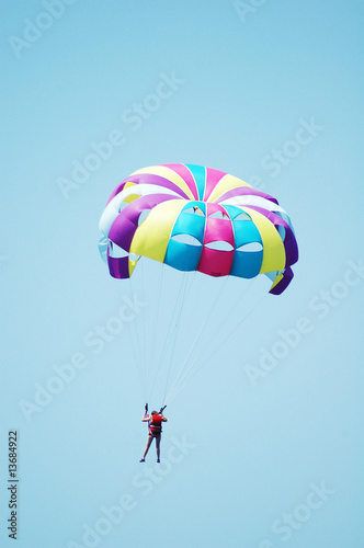 Multi coloured parachute over the blue sky