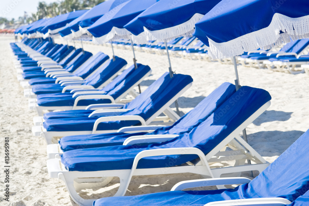 Rows of Beach Chairs and Umbrellas on a Deserted Beach Rows of Beach Chairs and Umbrellas on a Deserted Beach