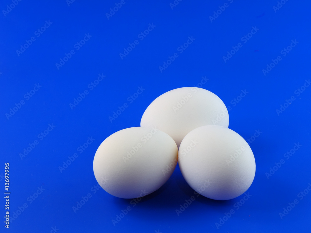 Easter time- Three eggs on blue background.Close-Up Easter time- Three eggs on blue background.Close-Up