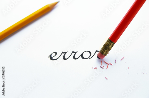 pencil erasing an "error" on white paper