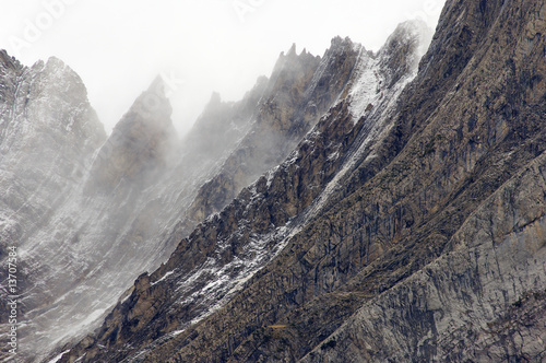 rugged mountains in the winter fog photo