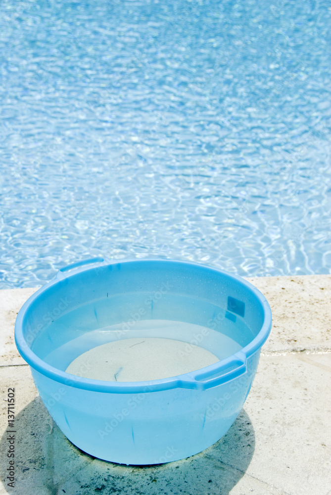 Bucket of Water Beside the Swimming Pool