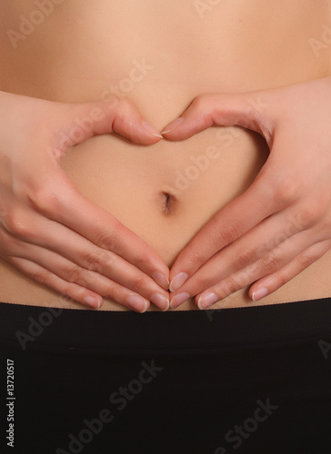 Wallpaper Mural Woman's hands around her navel in a heart shape Torontodigital.ca