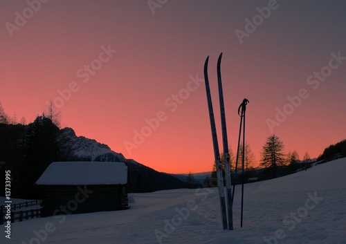 cross country skis and mountain shelter after sunset