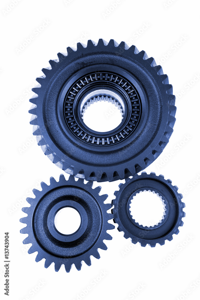 Three gears meshing together over white Three gears meshing together over white