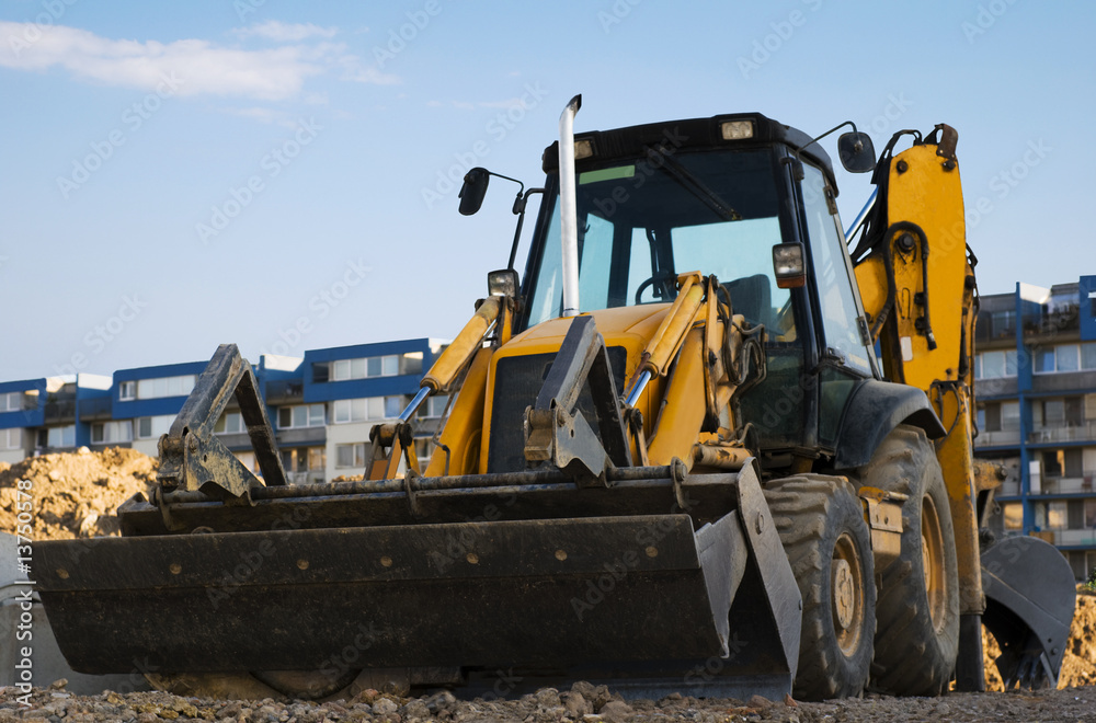 Excavator with a backhoe on the construction area