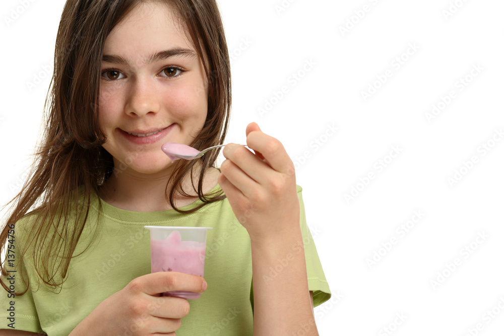 Girl eating yogurt isolated on white background Girl eating yogurt isolated on white background