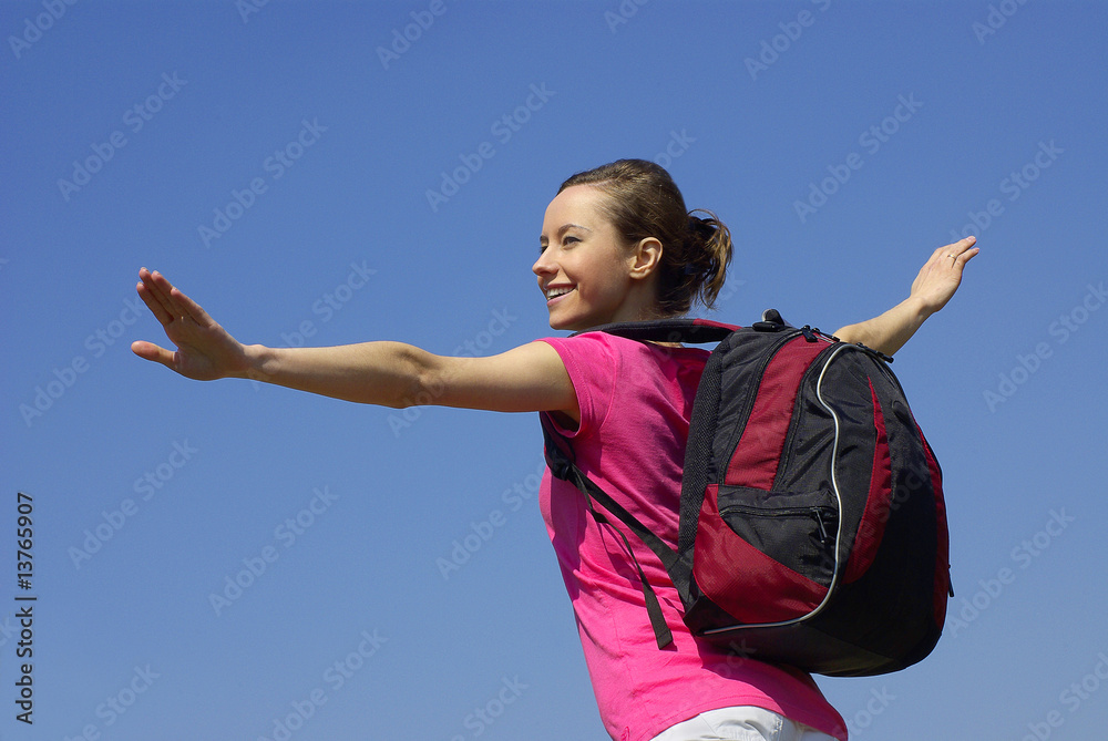 Sporty girl with backpack ready to fly