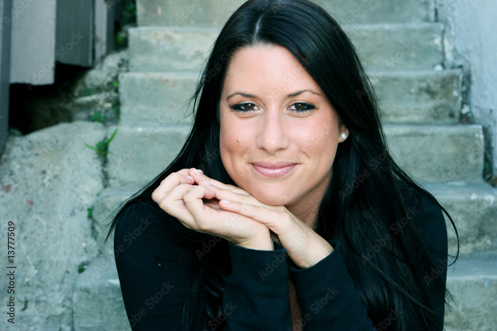 Fototapeta premium A beautiful student sitting on the steps