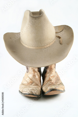 Old cowboy boots and hat front view