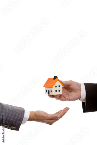 hand holdinh a small house - real state house credit concept