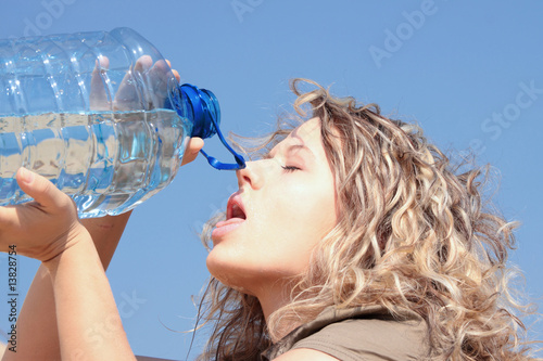 Thirsty blond woman on desert photo