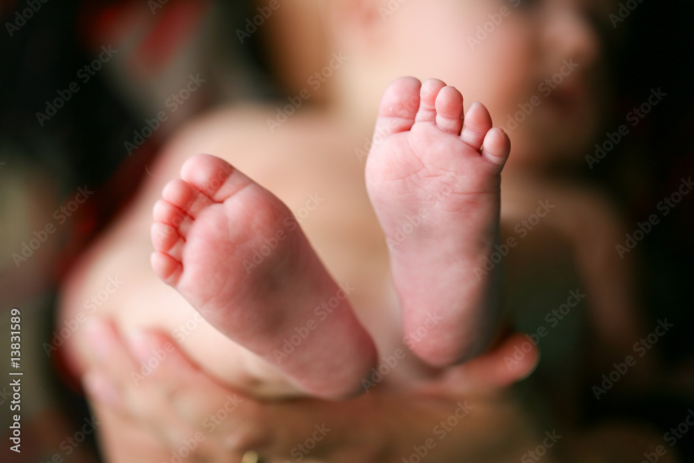 Father holding his child's feet Father holding his child's feet