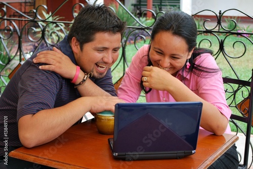 HIspanic couple on laptop
