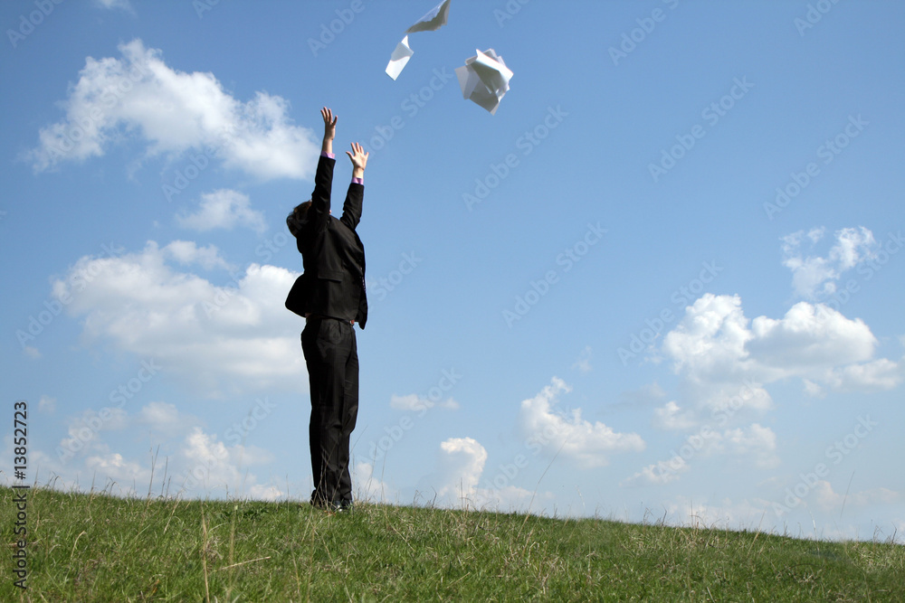 A business man freeing himself from his work load A business man freeing himself from his work load