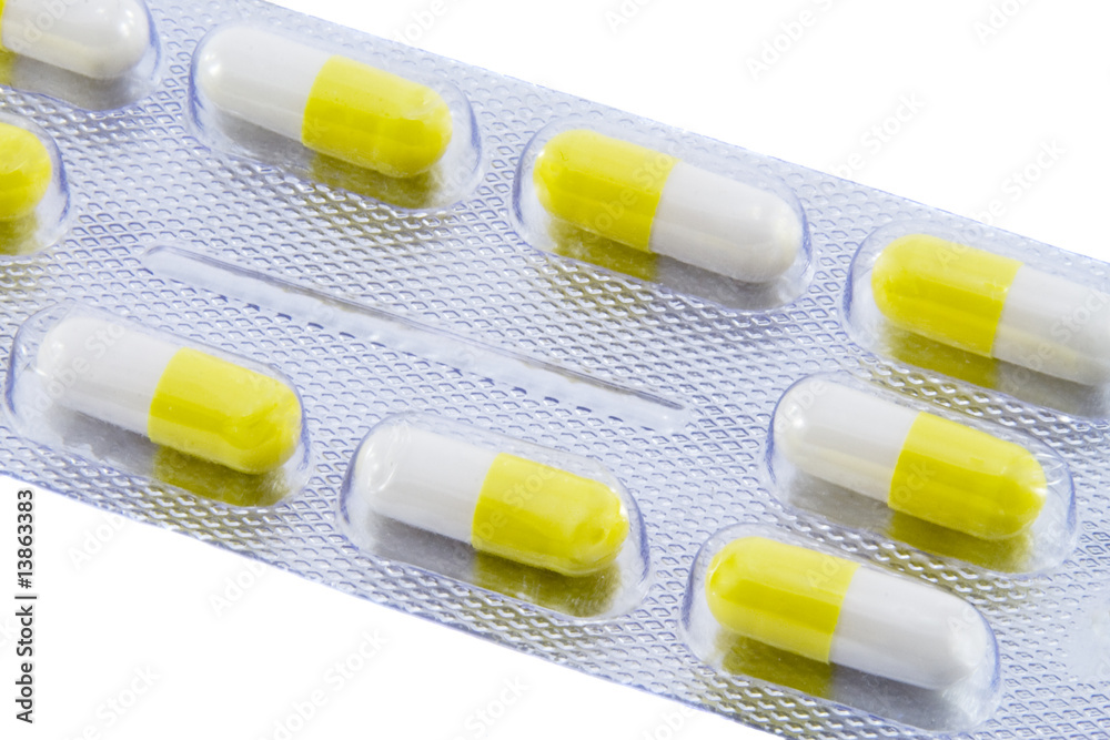 Many different color tablets and pills isolated over white backg
