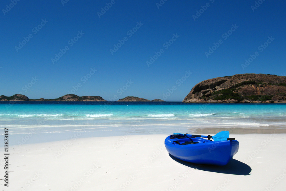 Blue canoe on a sandy beach