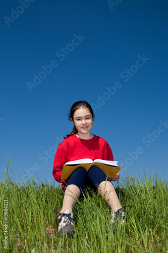 Girl reading book outdoor