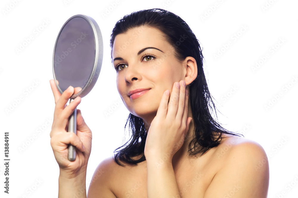 The beautiful young woman with a mirror