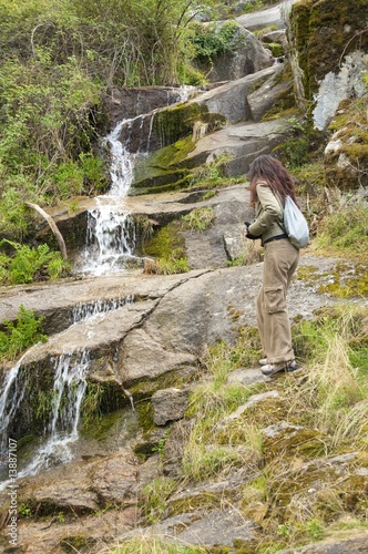 woman walking next to a torrent