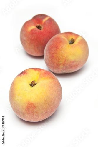 Peaches isolated on a white studio background.