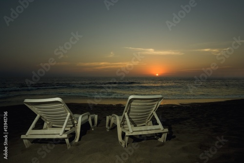Lounge chairs on a beach © Vibe Images