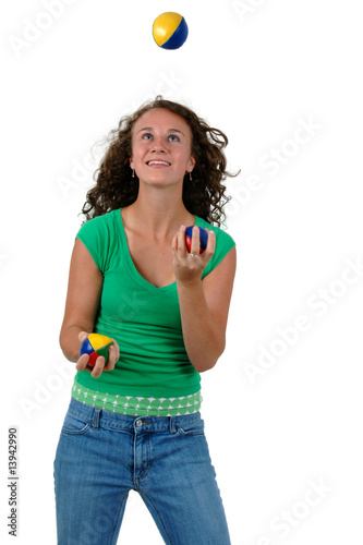 Isolated teenage girl juggling