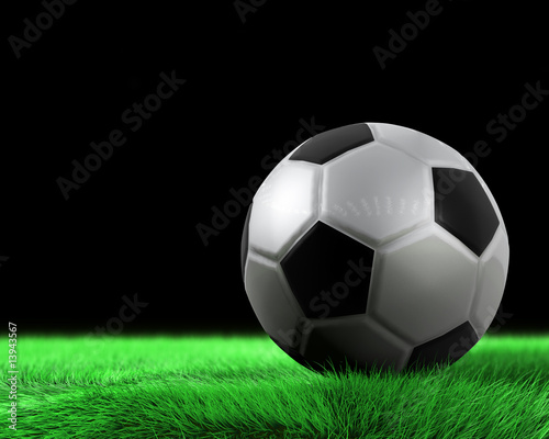 Soccerball and green grass in detail