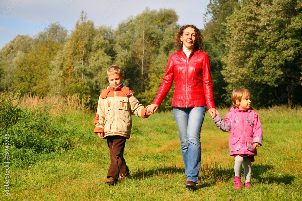 Obraz premium Mother with children on walk in wood, front view