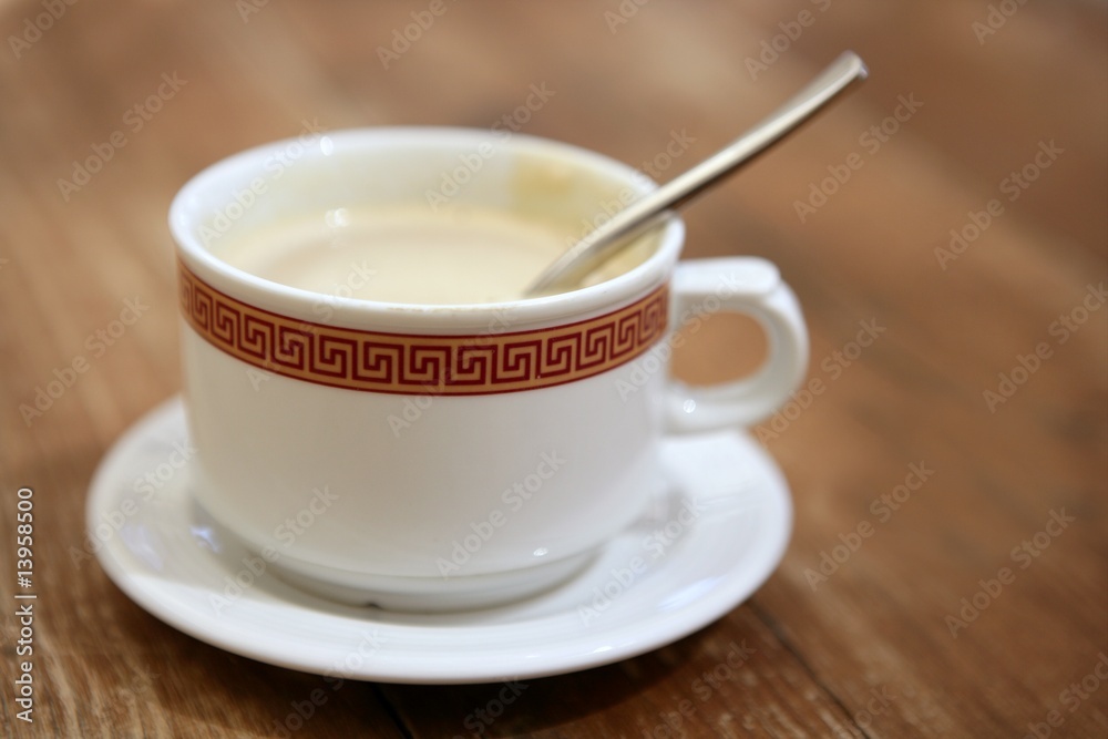 Coffe with milk white cup over teak wooden Coffe with milk white cup over teak wooden