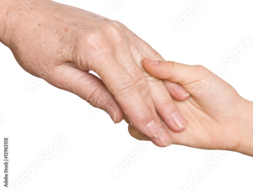 Grandmother and granddaughter hold hands.