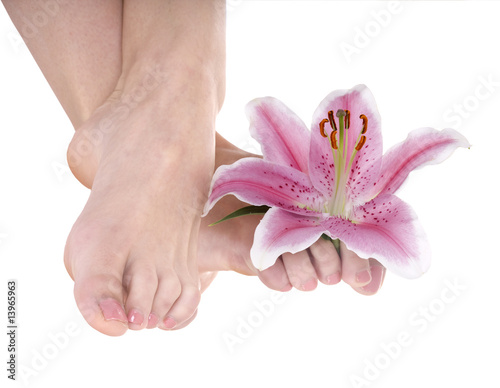 Woman foot with flower lily.