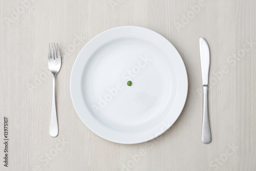 A single pea on a plate