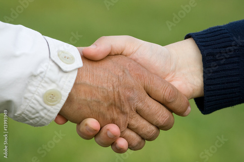 Old man hand shaking with young man