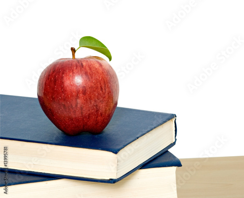 Red apple on pile of books