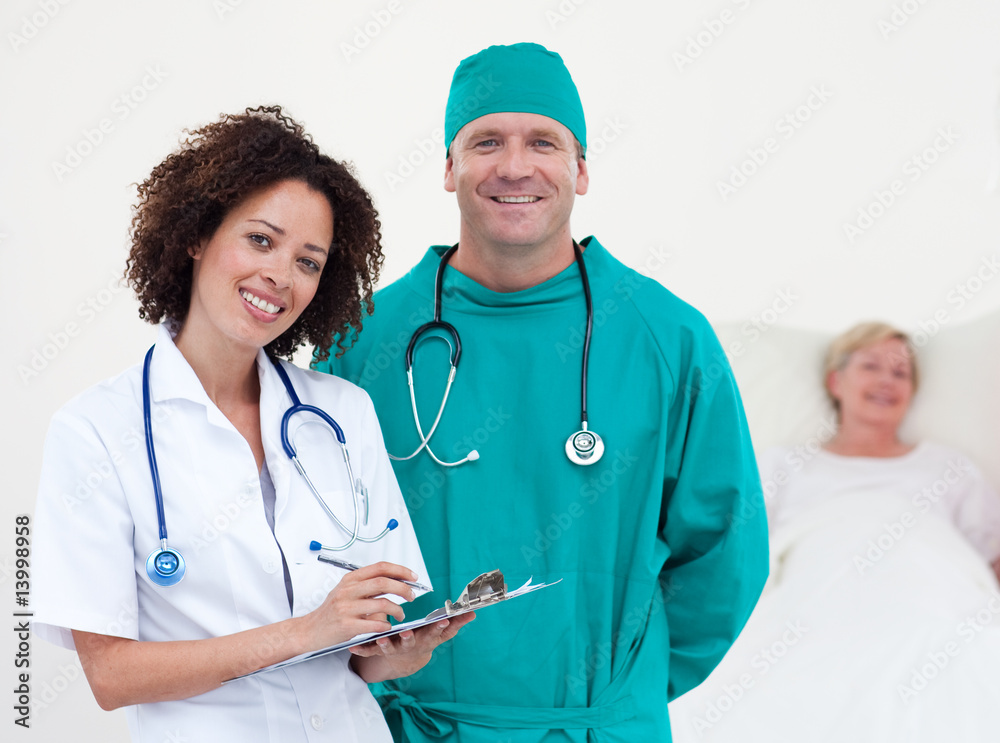 Doctors with their patient in the background Doctors with their patient in the background