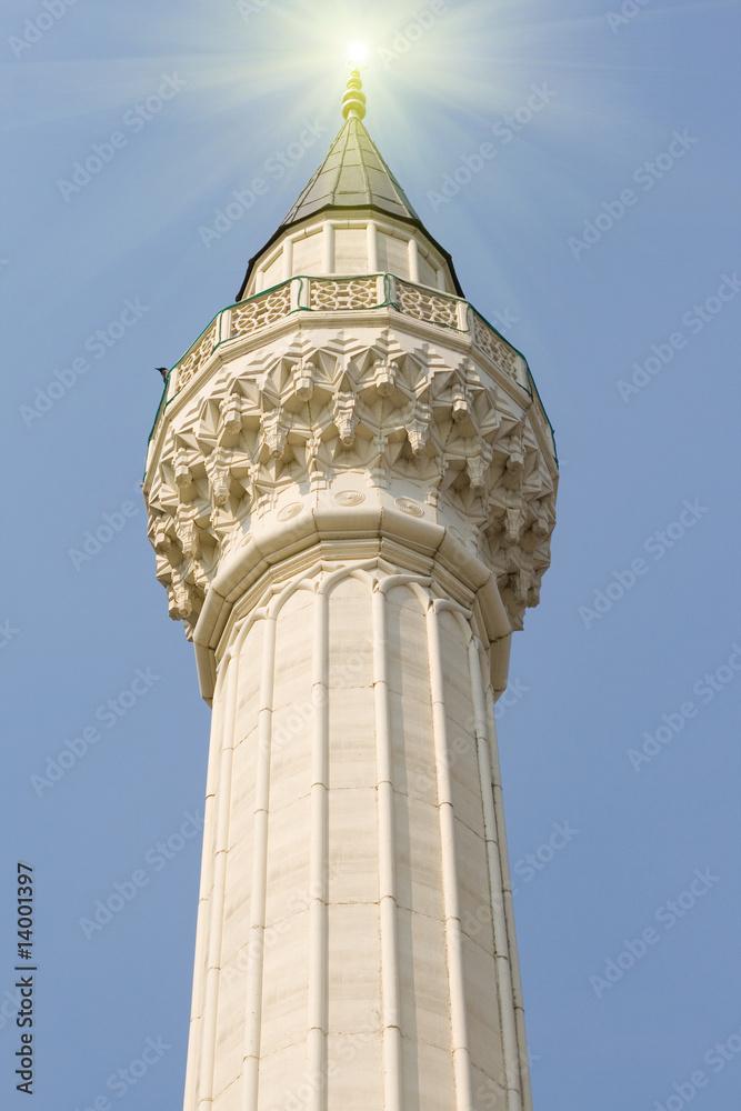 minaret of a mosque with sunlight