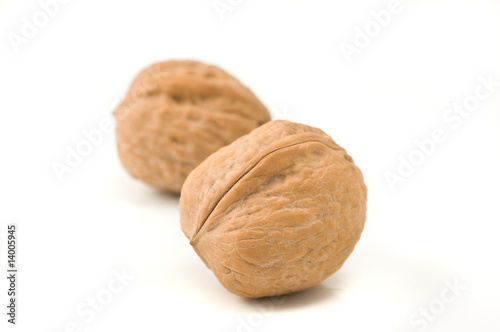 Two walnuts on white background
