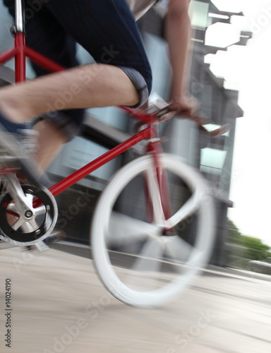 Panned shot of a fixed-gear bike rider