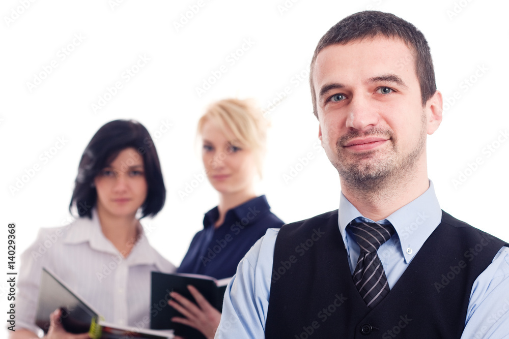 Business team - boss and two business women in the background Business team - boss and two business women in the background