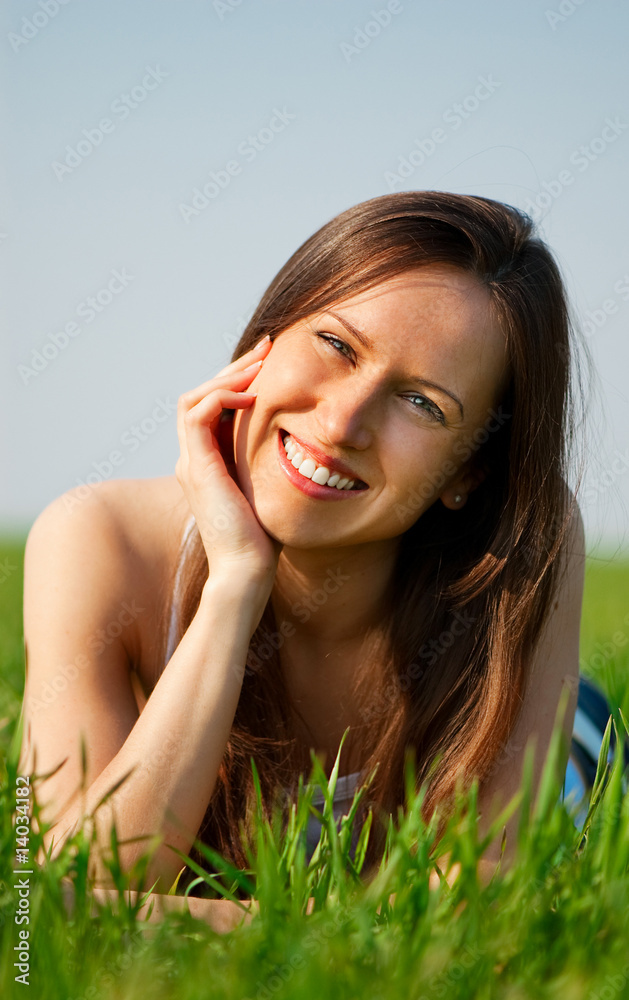 young woman relaxing at the grass young woman relaxing at the grass