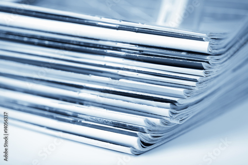 Foto stack of magazines toned blue isolated