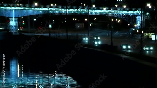 Night traffic near bridgeand river mirror photo