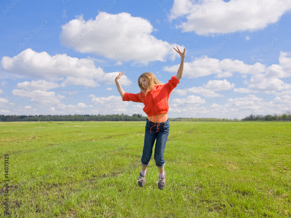 adolescent girl in a bright dress jumps on the lawn adolescent girl in a bright dress jumps on the lawn